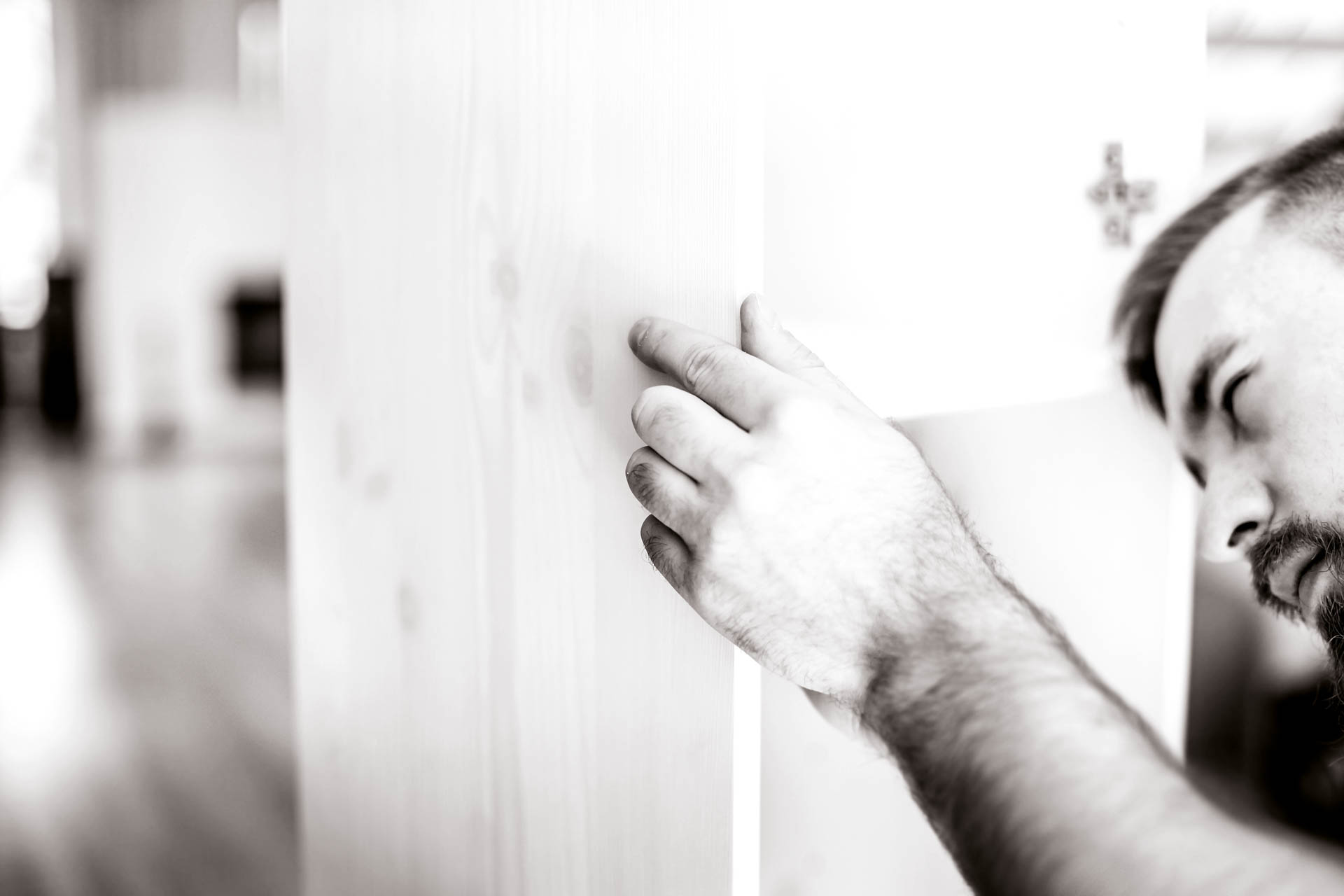 young man with a beard collects furniture in a new house